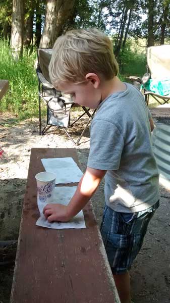 washing the rocks that he found on the hike