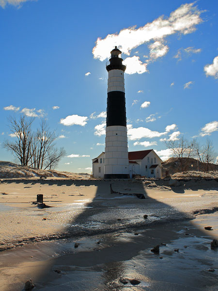 in the shadow of the big sable point lighthouse tower