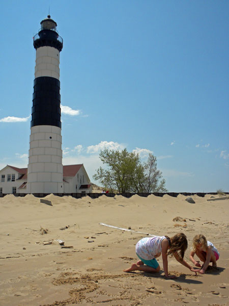 play at the beach in front of the big sable point lighthouse