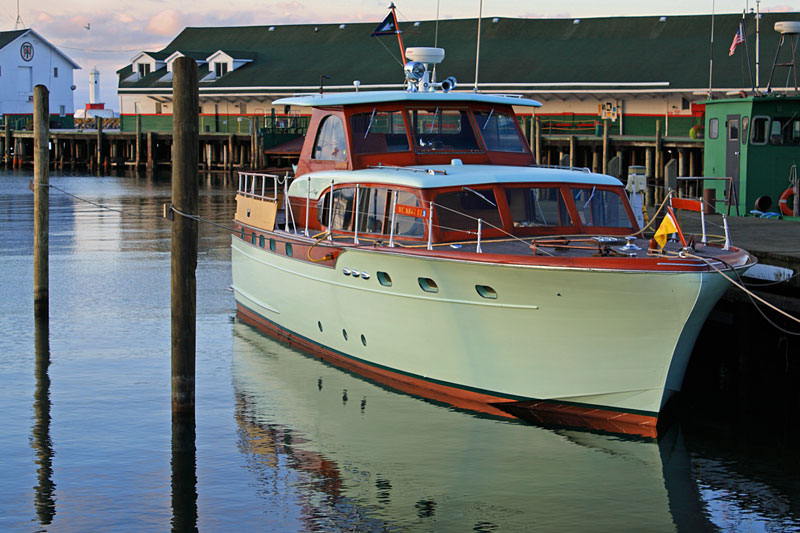 chris craft boat anchored in the harbor