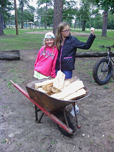 girls getting the firewood at marquette tourist park