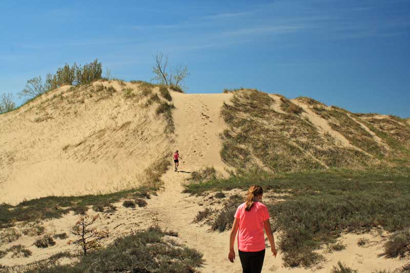 climbing over the dune to the channel campground