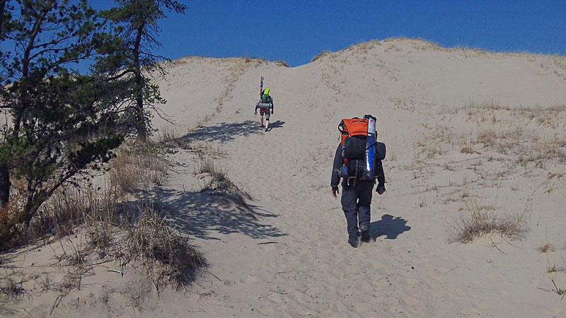 climbing over the last dune before big sable point