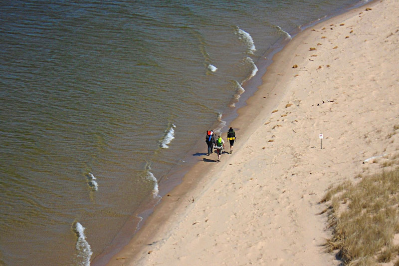 walking up the beach with backpack from the top of big sable lighthouse