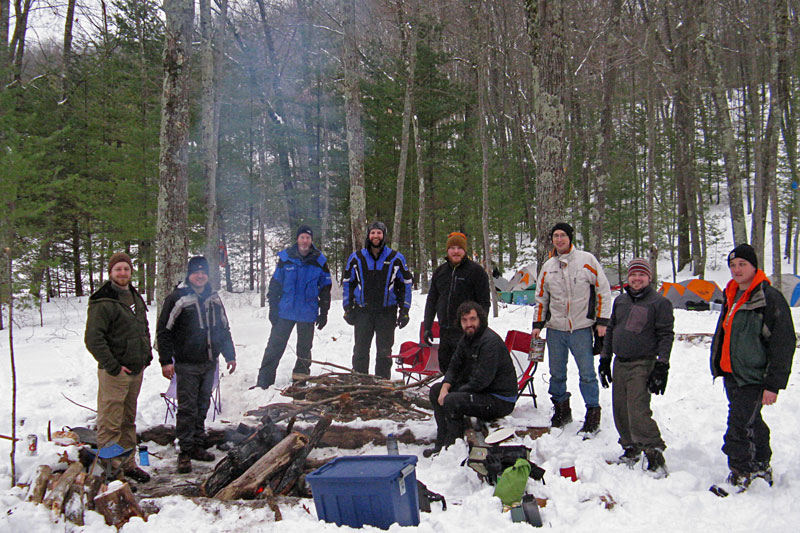 the winter camping group by fire lost lake campsite