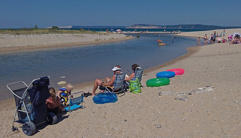 relaxing at the beach at platte river point in sleeping bear dunes