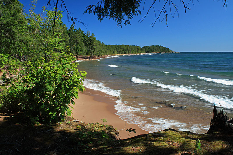 blue water of lake superior looking back to little presque isle