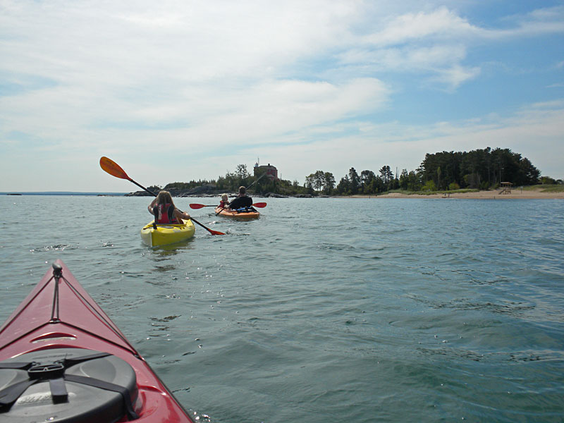 approaching the marquette lighthouse in the kayaks