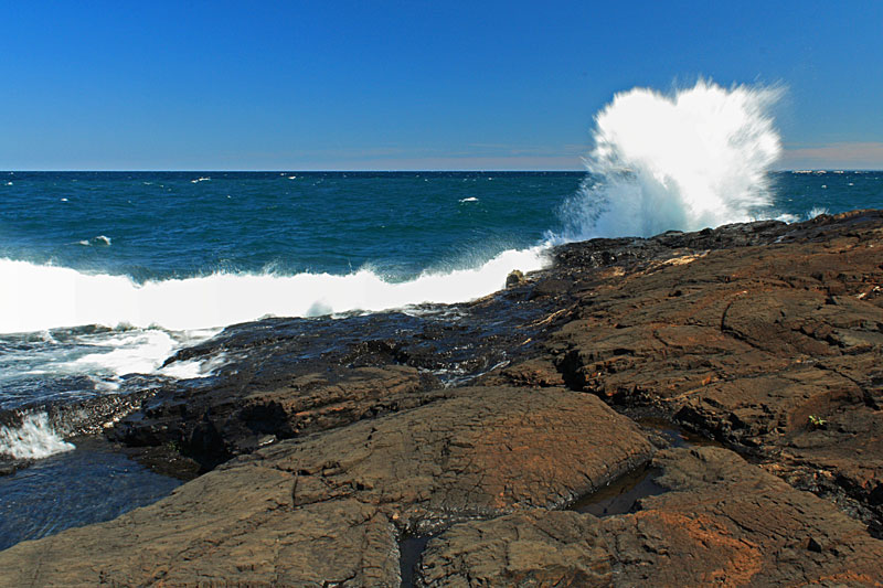 waves crashing black rocks presque isle park