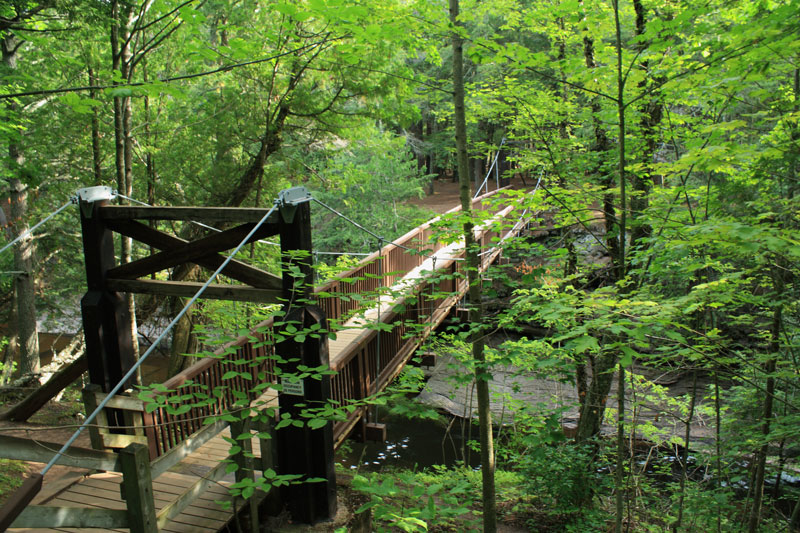 the suspension bridge over the presque isle river in the porkies