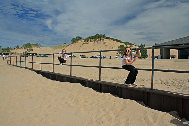 climbing on the rails by the beach