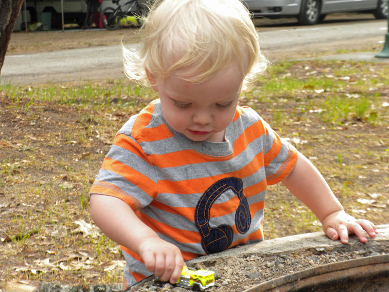 playing trucks by the fire pit